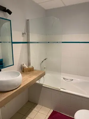 a bathroom with a tub and a sink and a shower at appartement T2 pour 6 personnes à Combloux in Combloux