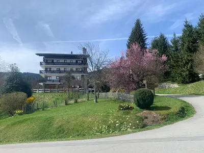 a house on a hill next to a road at appartement T2 pour 6 personnes à Combloux in Combloux