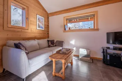 a living room with a couch and a table at Alpine Escape Facing the Aiguille du Midi in Chamonix-Mont-Blanc