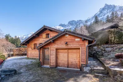 a log cabin with a large garage at Alpine Escape Facing the Aiguille du Midi in Chamonix-Mont-Blanc