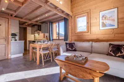 a living room with a couch and a table at Alpine Escape Facing the Aiguille du Midi in Chamonix-Mont-Blanc