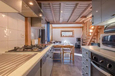 a kitchen with a stove and a counter top at Alpine Escape Facing the Aiguille du Midi in Chamonix-Mont-Blanc