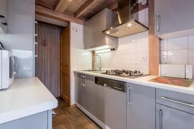 a kitchen with a stove and a sink at Alpine Escape Facing the Aiguille du Midi in Chamonix-Mont-Blanc