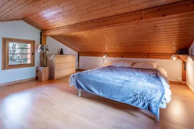 a bedroom with a bed with a wooden ceiling at Alpine Escape Facing the Aiguille du Midi in Chamonix-Mont-Blanc
