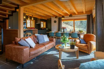 a living room with a couch and a table at Chalet Chantalhys - OVO Network in Saint-Gervais-les-Bains