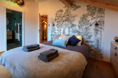 a bedroom with two large beds with towels on them at Chalet Chantalhys - OVO Network in Saint-Gervais-les-Bains