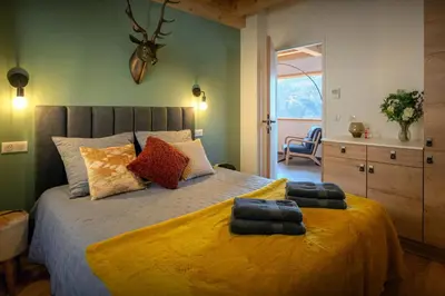 a bedroom with a bed with two pillows on it at Chalet Chantalhys - OVO Network in Saint-Gervais-les-Bains