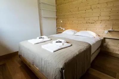 a bedroom with a large bed with towels on it at Apartment Chalet des Granges in Les Houches