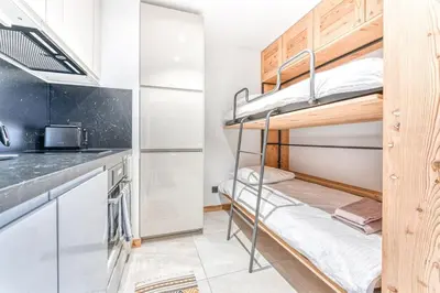 a small kitchen with bunk beds in a room at Barrats Studio - modern with Mont Blanc view in Chamonix-Mont-Blanc
