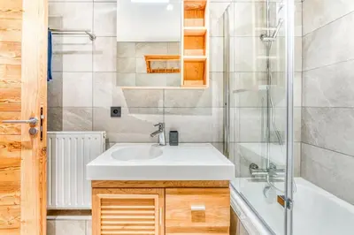 a bathroom with a sink and a shower at Barrats Studio - modern with Mont Blanc view in Chamonix-Mont-Blanc