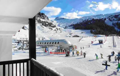 a group of people on a ski slope in the snow at Résidence Odalys Le Panoramic in Flaine