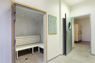 a sliding glass door leading into a room with a bench at Résidence Odalys Le Panoramic in Flaine