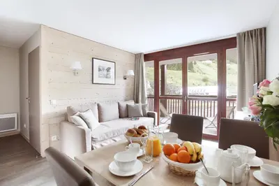 a living room with a table with fruit on it at Résidence Odalys Le Panoramic in Flaine