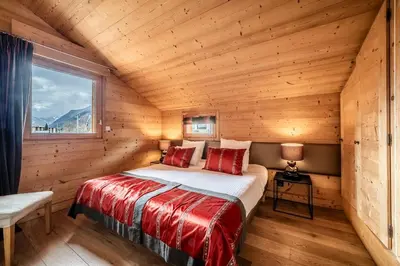 a bedroom with a bed in a log cabin at Chalet Inari Chamonix - by EMERALD STAY in Chamonix-Mont-Blanc
