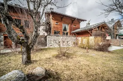 a large wooden house with a tree in front of it at Chalet Inari Chamonix - by EMERALD STAY in Chamonix-Mont-Blanc