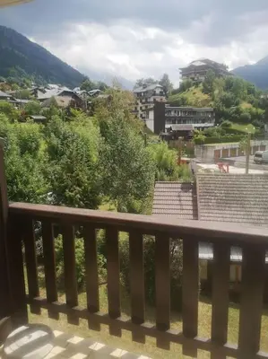 a balcony with a view of a city at Studio cabine 4 personnes, votre refuge montagnard in Saint-Gervais-les-Bains