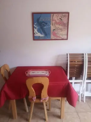 a dining room table with a red table cloth on it at Studio cabine 4 personnes, votre refuge montagnard in Saint-Gervais-les-Bains