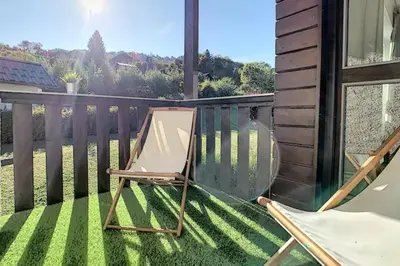 a deck with a chair on a balcony at Le Refuge Diorama in Saint-Gervais-les-Bains