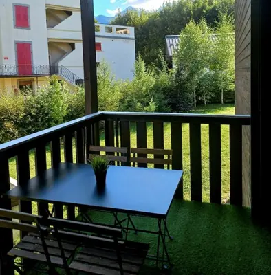 a table and two chairs on a balcony at Le Refuge Diorama in Saint-Gervais-les-Bains