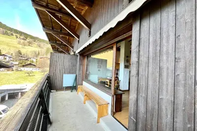 a wooden balcony with a bench on a building at L’Héritage Régence in Megève