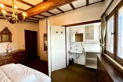 a bathroom with a bed and a sink in a room at L’Héritage Régence in Megève