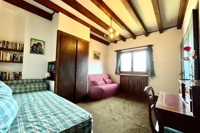 a bedroom with a bed and a chair and a window at L’Héritage Régence in Megève