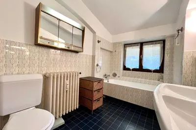 a bathroom with a toilet and a tub and a sink at L’Héritage Régence in Megève