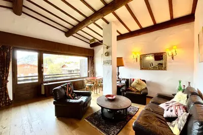 a living room with a couch and a table at L’Héritage Régence in Megève