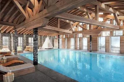 a large swimming pool in a large building at L'Altima Megève - Eclat des Veriaz in Megève