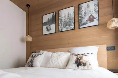 a bedroom with a bed with a picture of a deer on it at L'Altima Megève - Eclat des Veriaz in Megève