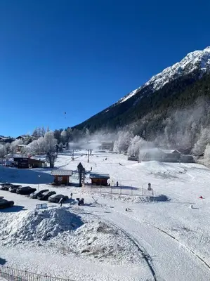 a snow covered mountain with a ski slope with people at Pied des pistes/Hyper centre/Balcon/Parking in Chamonix-Mont-Blanc