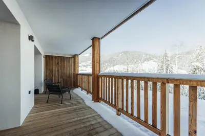 a balcony with a view of the snow covered mountains at Le Cocon Blanc - Appartement « cosy & chic » in Megève