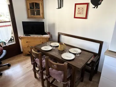 a dining room table with plates on top of it at Résidence Le Royal - Charmant T3 dans le centre de Combloux MAE-2721 in Combloux