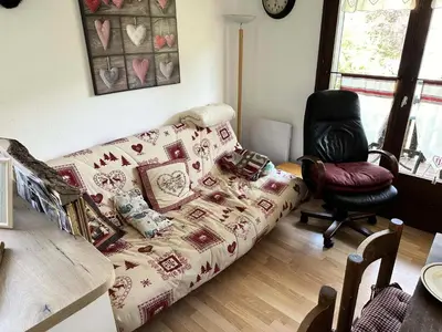a living room with a couch and a chair at Résidence Le Royal - Charmant T3 dans le centre de Combloux MAE-2721 in Combloux