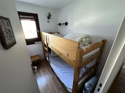 a bunk bed in a small room with a window at Résidence Le Royal - Charmant T3 dans le centre de Combloux MAE-2721 in Combloux