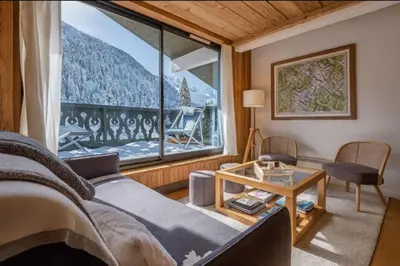 a room with a bed and a large window at Beautiful apartment with superb view of Mont Blanc in Chamonix-Mont-Blanc