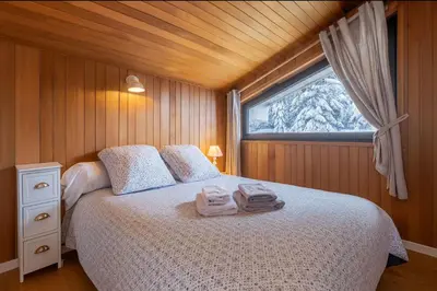 a table on a balcony with a view of mountains at Beautiful apartment with superb view of Mont Blanc in Chamonix-Mont-Blanc