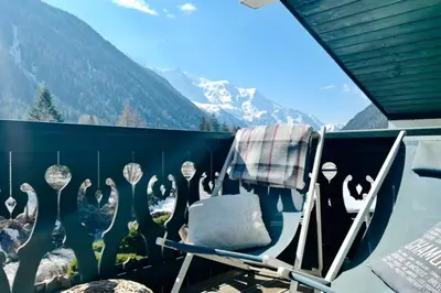 a dining room with a table and a large window at Beautiful apartment with superb view of Mont Blanc in Chamonix-Mont-Blanc