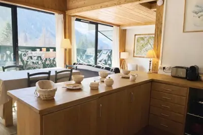 a bedroom with a bed with a large window at Beautiful apartment with superb view of Mont Blanc in Chamonix-Mont-Blanc
