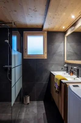 a bathroom with a sink and a shower and a window at Charmant appartement dans chalet, coeur de Megève in Megève