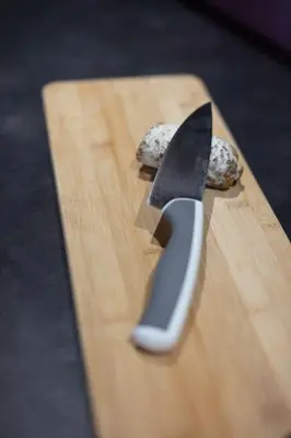 a knife sitting on top of a wooden cutting board at Charmant appartement dans chalet, coeur de Megève in Megève