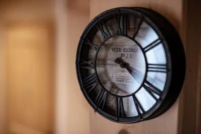 a black clock on a wall on a wall at Charmant appartement dans chalet, coeur de Megève in Megève