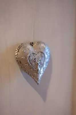 a heart shaped object is hanging on a door at Charmant appartement dans chalet, coeur de Megève in Megève