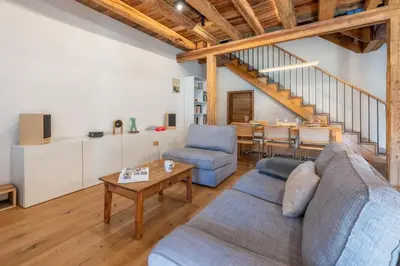 a living room with a couch and a table at Pretty loft with view of Mont Blanc & glacier in Chamonix-Mont-Blanc