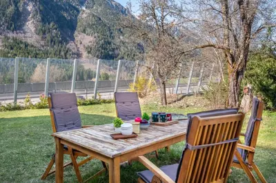 a wooden table with four chairs around it at Pretty loft with view of Mont Blanc & glacier in Chamonix-Mont-Blanc