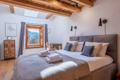 a bedroom with a large bed with two pillows on it at Pretty loft with view of Mont Blanc & glacier in Chamonix-Mont-Blanc