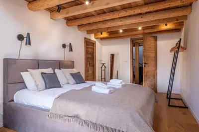 a bedroom with a large bed in a room with wooden ceilings at Pretty loft with view of Mont Blanc & glacier in Chamonix-Mont-Blanc