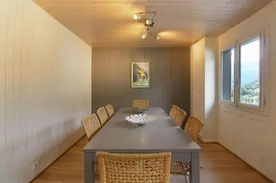 a dining room with a gray table and chairs at Chalet La Cordée, 160m2, 4 chambres, sauna in Saint-Gervais-les-Bains