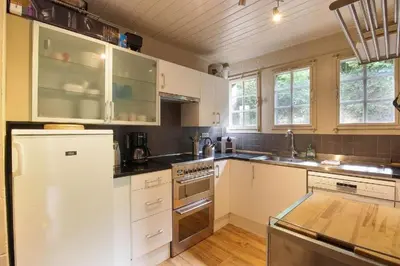 a kitchen with white cabinets and white appliances at Chalet La Cordée, 160m2, 4 chambres, sauna in Saint-Gervais-les-Bains