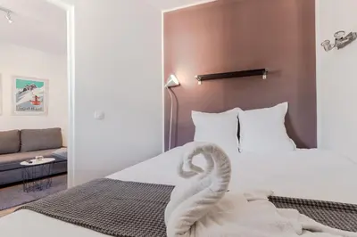 a room with a bed with a swan on it at Le Balcon du Brevent - Central - Vue montagne in Chamonix-Mont-Blanc